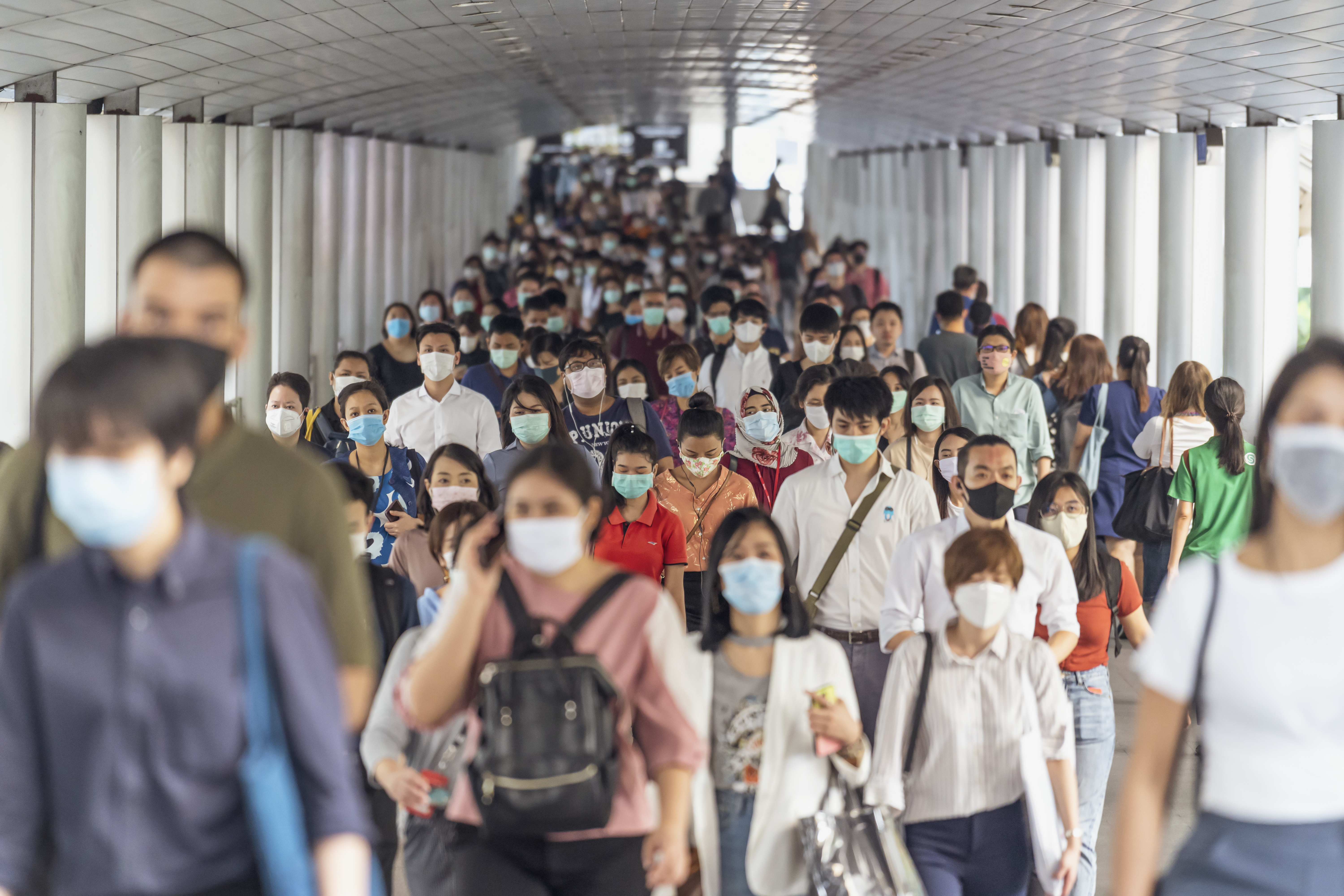 Photo showing a large group of people all wearing surgical masks