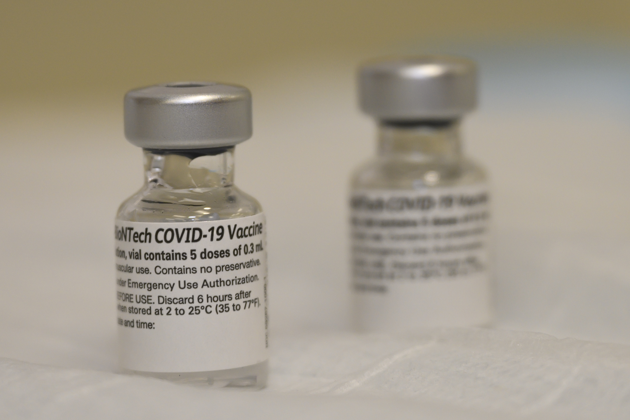 Photo showing two glass containers of COVID-19 vaccine